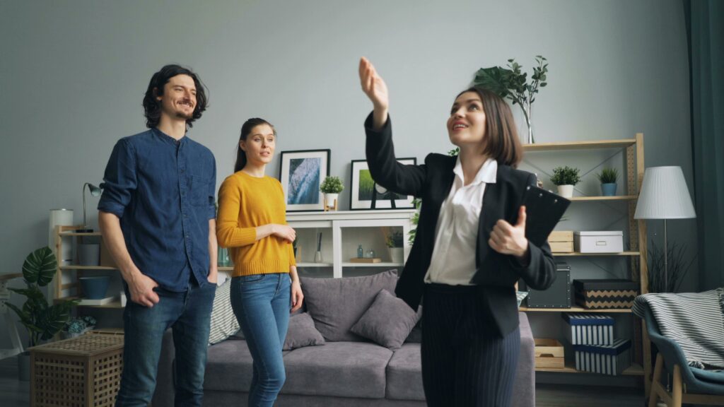 A real estate agent with a couple selling a Vancouver penthouse