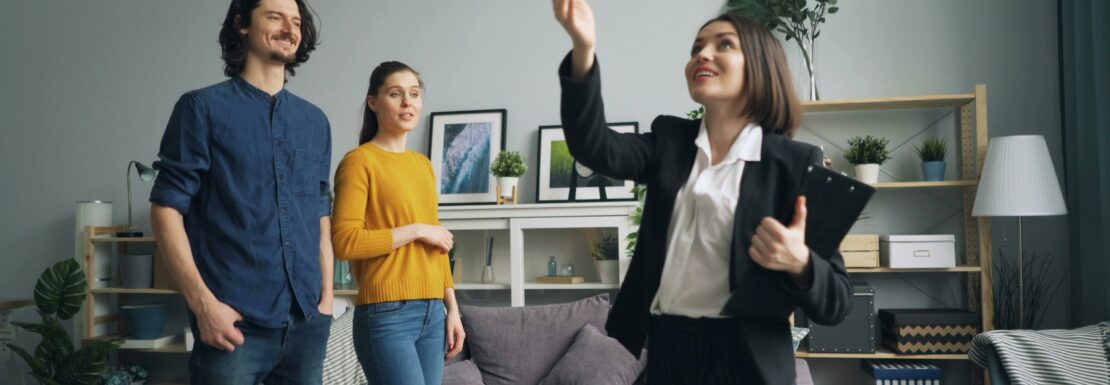 A real estate agent with a couple selling a Vancouver penthouse